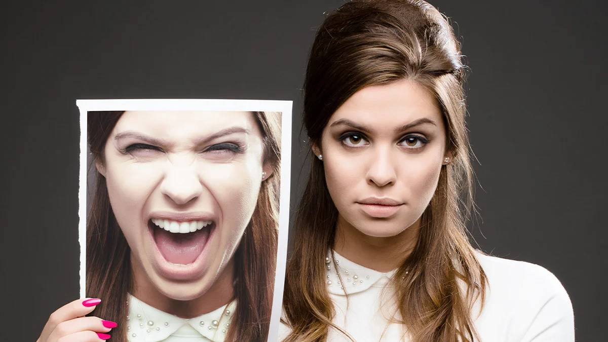 Women holding an image of her head, with that image being of her screaming.