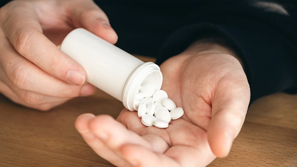 pills being poured into a hand